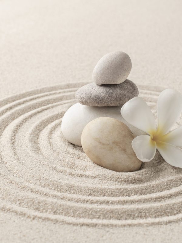 Stacked zen stones sand background art of balance concept